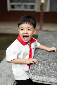 Close-up of cute boy smiling outdoors