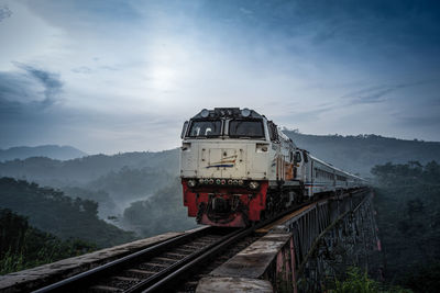 Train on railroad track against sky