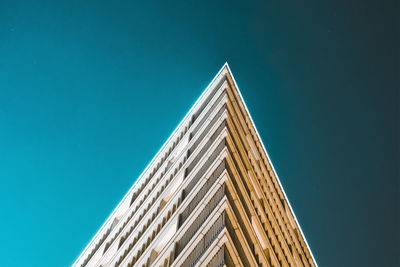 Low angle view of modern building against clear blue sky