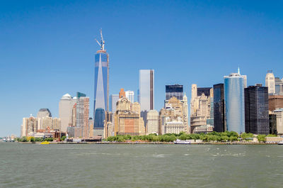 Modern buildings in city against blue sky