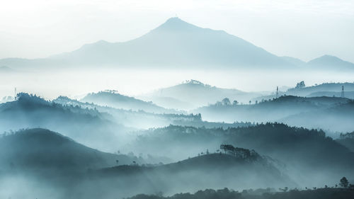 Scenic view of mountains in foggy weather