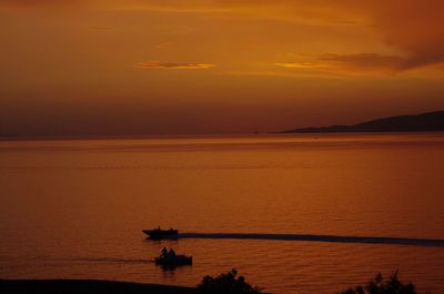 Scenic view of sea against orange sky