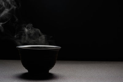 Close-up of coffee on table against black background