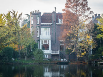 Reflection of trees and buildings in lake