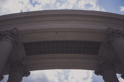 Low angle view of building against cloudy sky