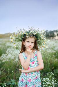 Portrait of happy girl standing on field