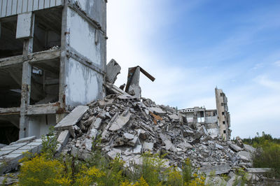 Low angle view of abandoned building against sky