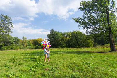 Full length of boy on field against sky