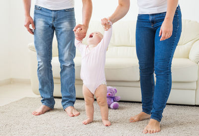 Parents playing with daughter at home