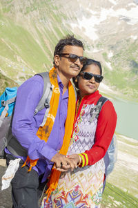 Portrait of young couple standing outdoors