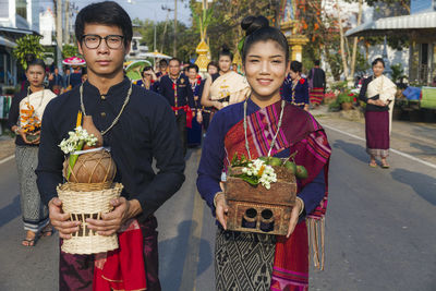 Portrait of friends standing in basket