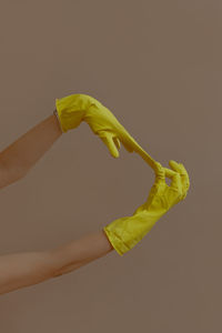 Woman holding yellow leaf over white background