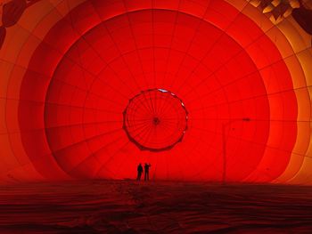 Silhouette people with hot air balloon at desert