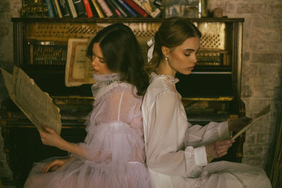 Side view of woman looking at camera