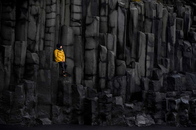 Woman sitting on rock column formation