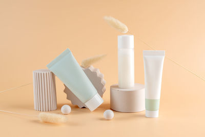 Close-up of beauty products against pink background