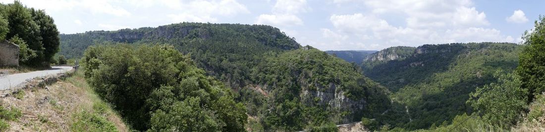 Scenic view of mountains against cloudy sky