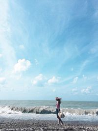 Man standing on beach against sky