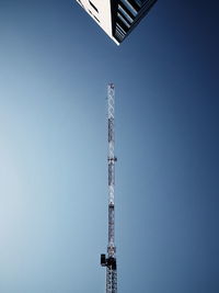 Low angle view of communications tower against clear sky