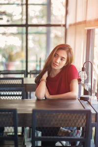 Beautiful woman looking away while sitting at restaurant