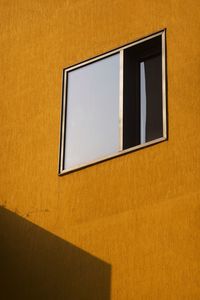 Close-up of yellow window on wall