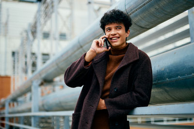 Portrait of young man using mobile phone