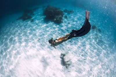 Low section of woman swimming in sea