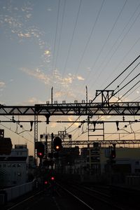 Cars on illuminated city against sky at sunset