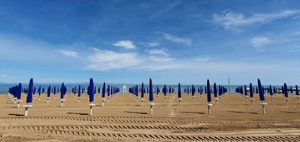 Scenic view of beach against blue sky