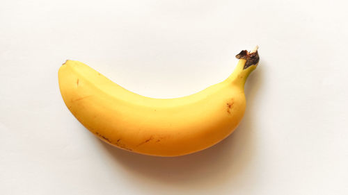 High angle view of yellow fruit on white background