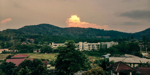 High angle view of townscape and mountains against sky