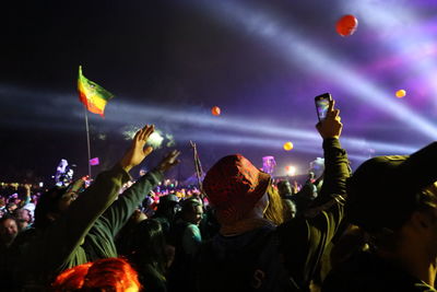 People enjoying music concert at night