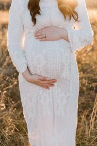 Midsection of woman standing on field