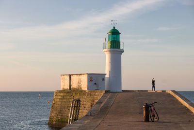 Entrance to the port of les sables d'olonne with the small pier and its leaning green lighthouse