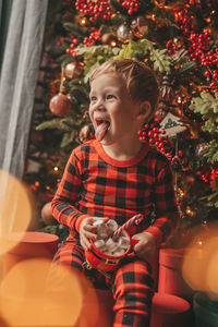 Portrait of boy playing christmas tree