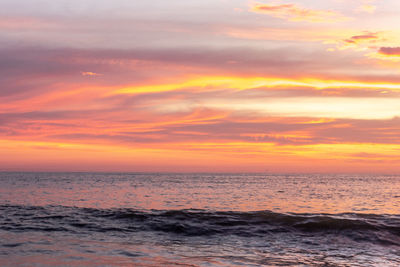 Scenic view of sea against orange sky