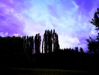 Low angle view of silhouette trees against sky at dusk