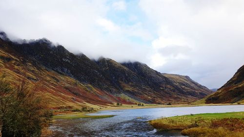 Scenic view of lake and mountains against sky