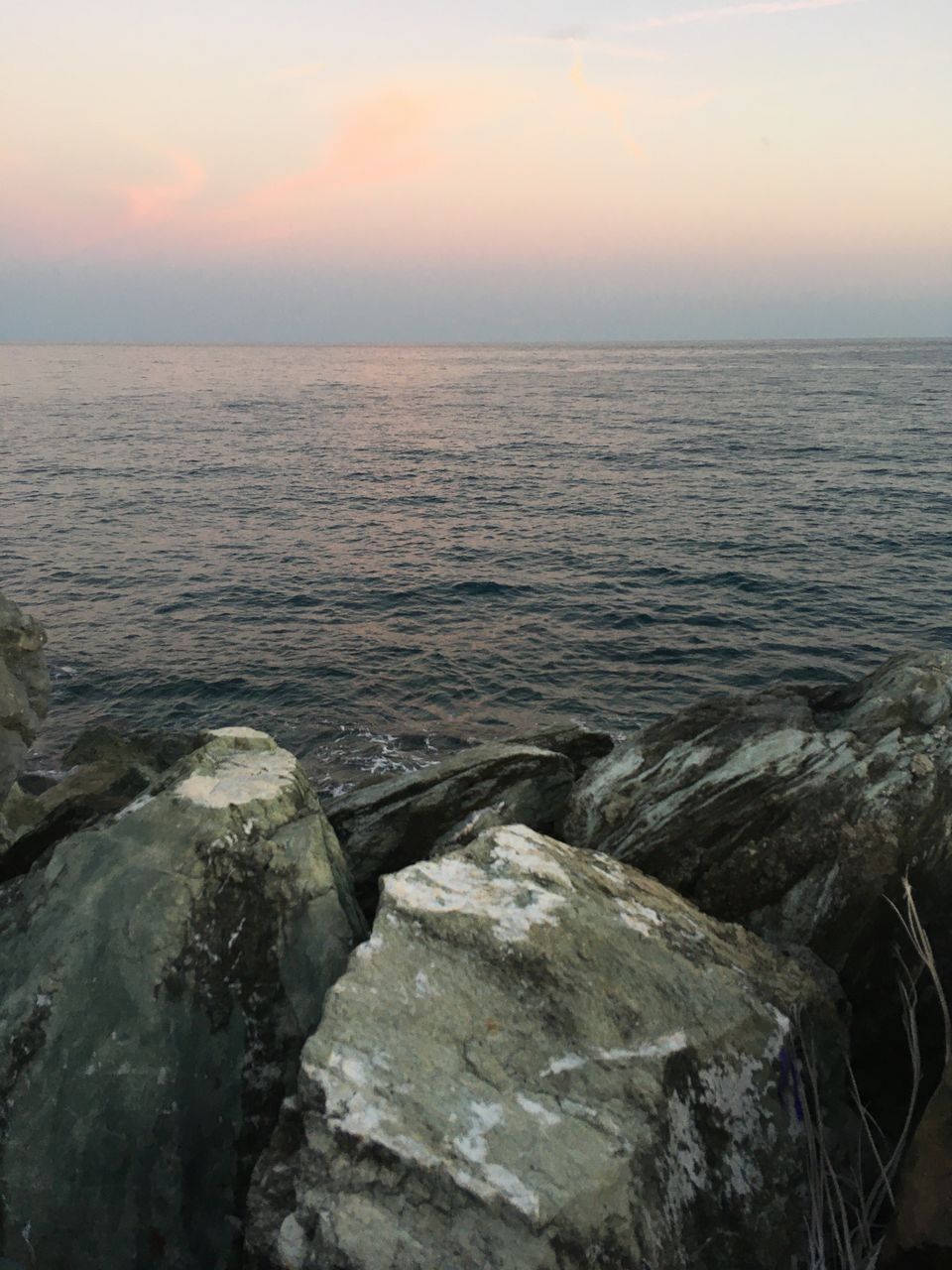 SCENIC VIEW OF ROCKS IN SEA AGAINST SKY