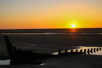 Scenic view of sea against clear sky during sunset