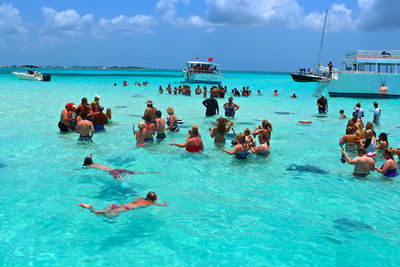 People enjoying in sea on sunny day