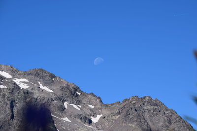 Scenic view of mountains against clear blue sky