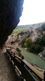 Scenic view of river by mountains against clear sky