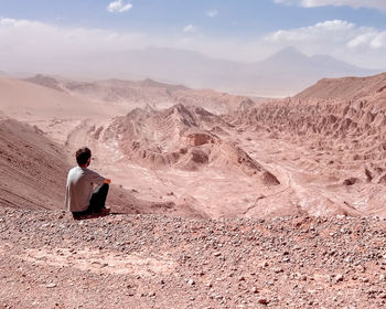 Rear view of man walking on mountain