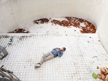 High angle view of man lying on floor
