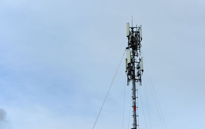 Low angle view of communications tower against sky