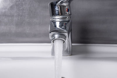 Close-up of water faucet in bathroom at home