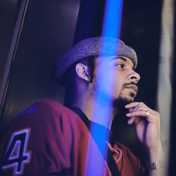 Low angle view of thoughtful man seen through window