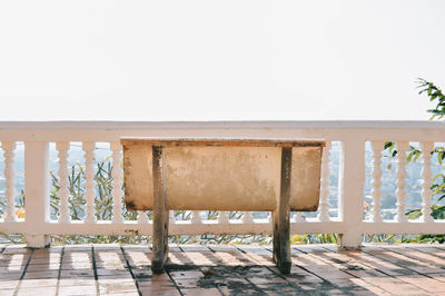 Empty chairs against clear sky