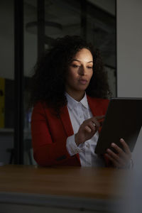 Businesswoman using tablet pc at desk in office